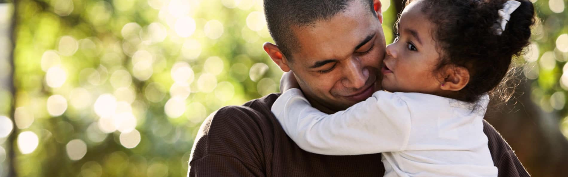 Latino father holding his baby daughter