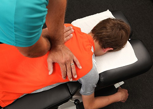 A Chiropractor adjusting a child