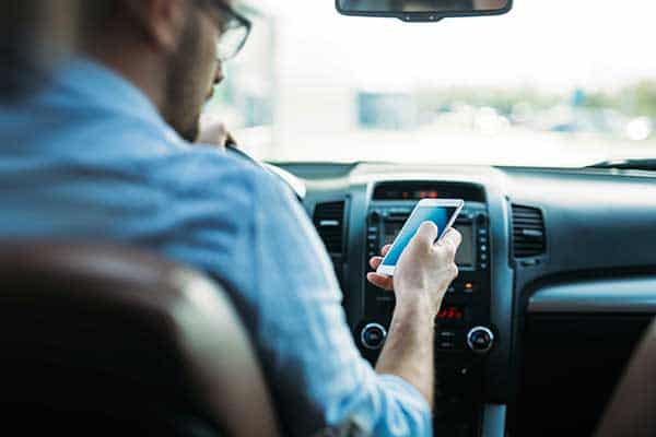 man driving on cell phone